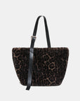 Leopard print handbag with a black strap on a light gray background