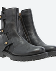 Pair of black leather boots with buckles and zippers on a white background