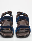 Pair of blue and brown sandals on a white background