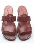 Pair of brown leather sandals on a white background