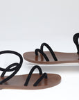 Pair of sandals with black straps on a white background