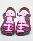Pair of pink metallic sandals on a white background