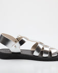 Silver sandal with black sole on a white background