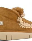 A brown MOU bounce sneaker with hand-crochet wool stitching and a chunky sole.