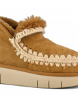 A brown MOU bounce sneaker with hand-crochet wool stitching and a flat rubber sole.