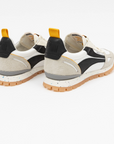 Pair of white sneakers with black and gray accents on a white background