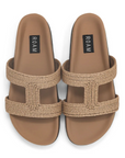 A pair of ROAM raffia cuff sandals in natural color with cutout straps and a flat sole.