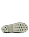 Close-up of a shoe sole with a textured pattern on a white background