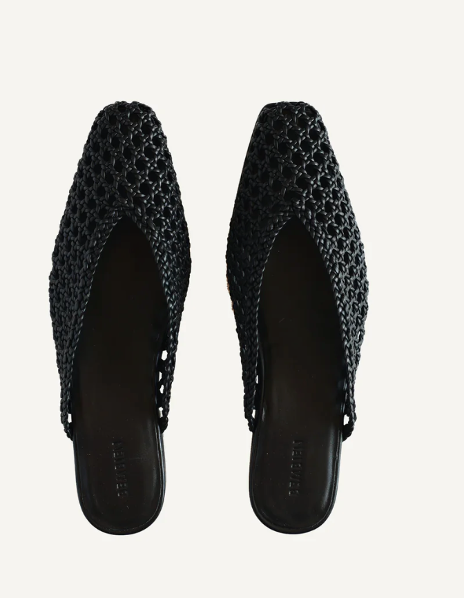 Pair of black woven shoes on a light gray background