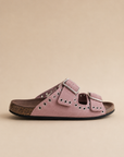 Pink sandal with a buckle on a beige background