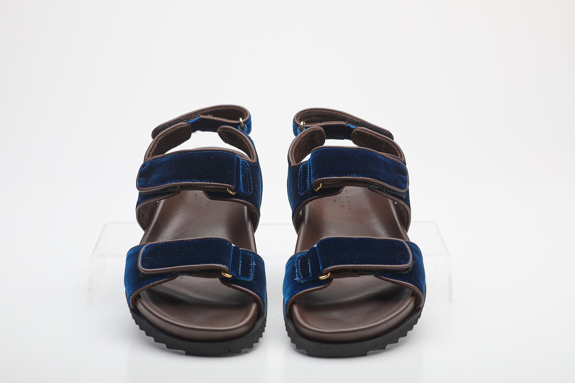 Pair of blue and brown sandals on a white background