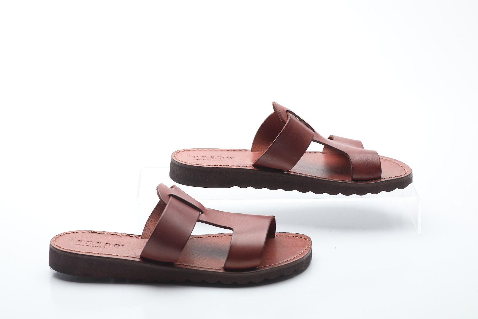 Pair of brown sandals on a white background