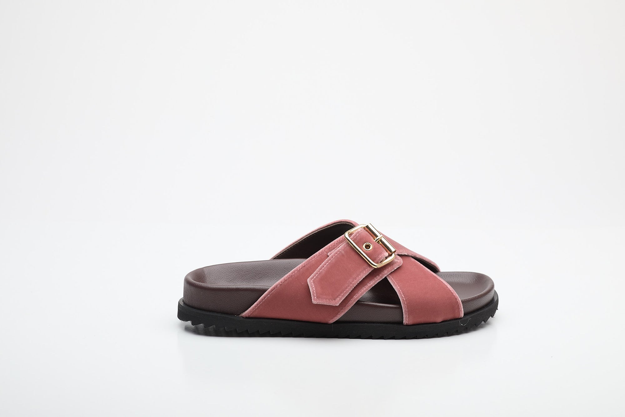 Pink sandal with a buckle on a white background