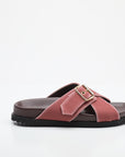Pink sandal with a buckle on a white background
