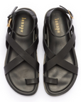 A pair of black strappy sandals with a polyurethane outersole, handcrafted in Italy.