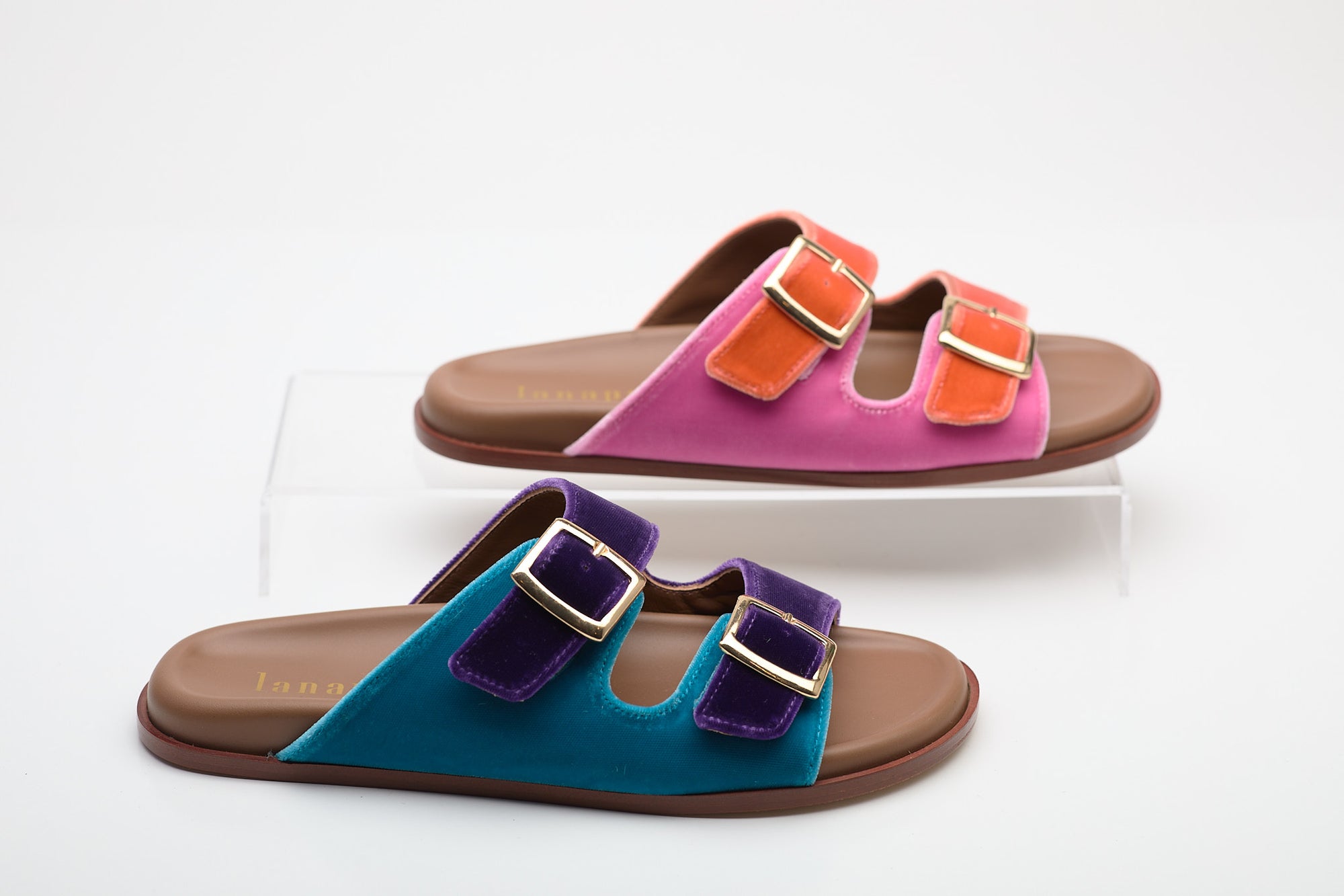 Colorful sandals with multiple buckles on a light gray background