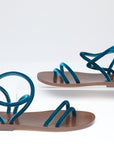Pair of sandals with blue straps on a white background