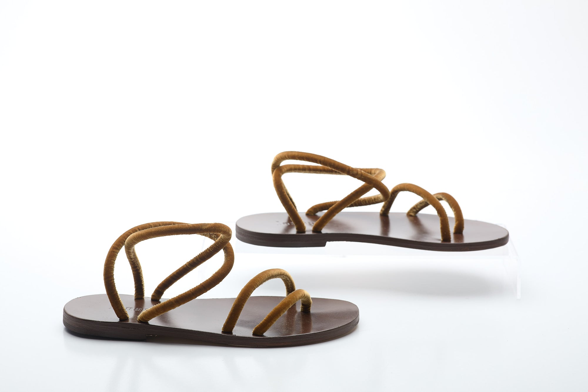 Pair of brown sandals on a white background
