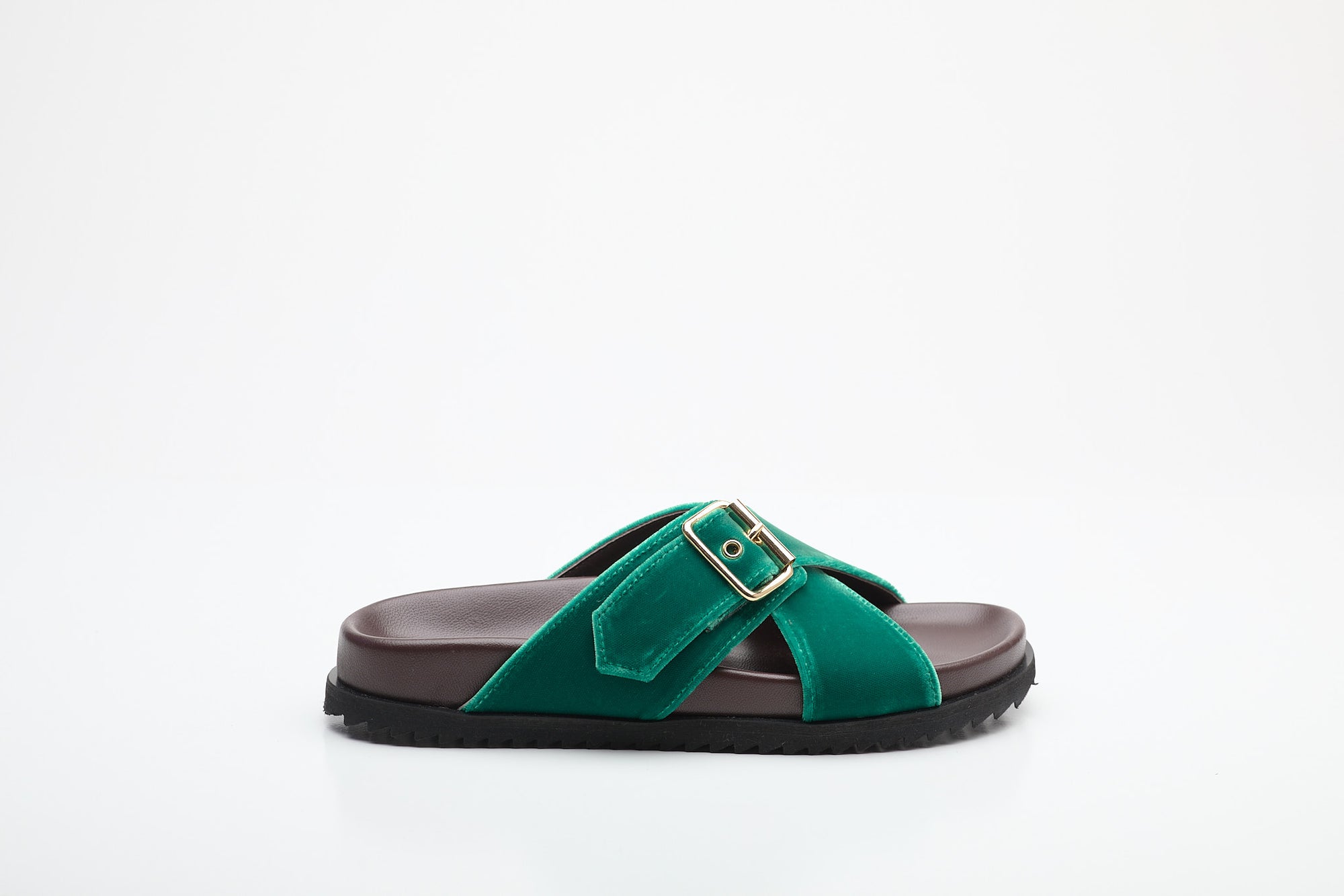 Green sandal with a strap and buckle on a white background