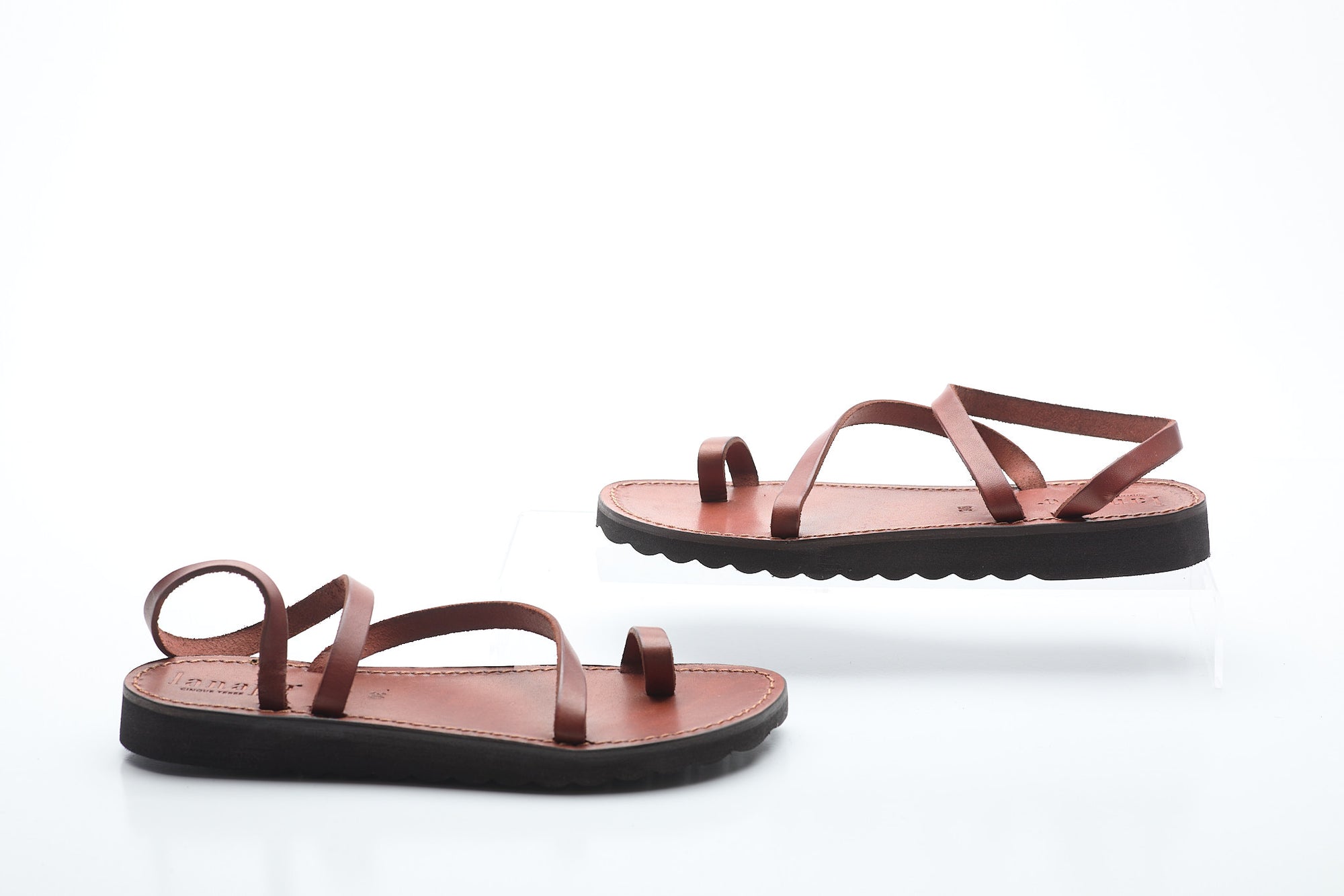 Pair of brown sandals on a white background