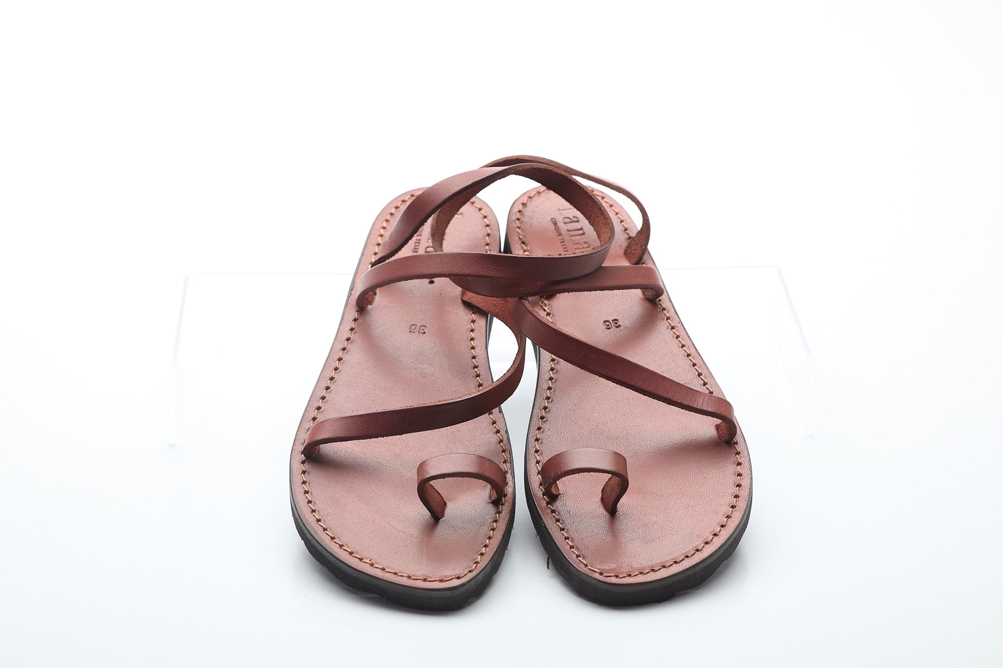Pair of brown sandals on a white background