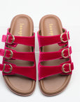 Pair of pink sandals with brown soles on a white background