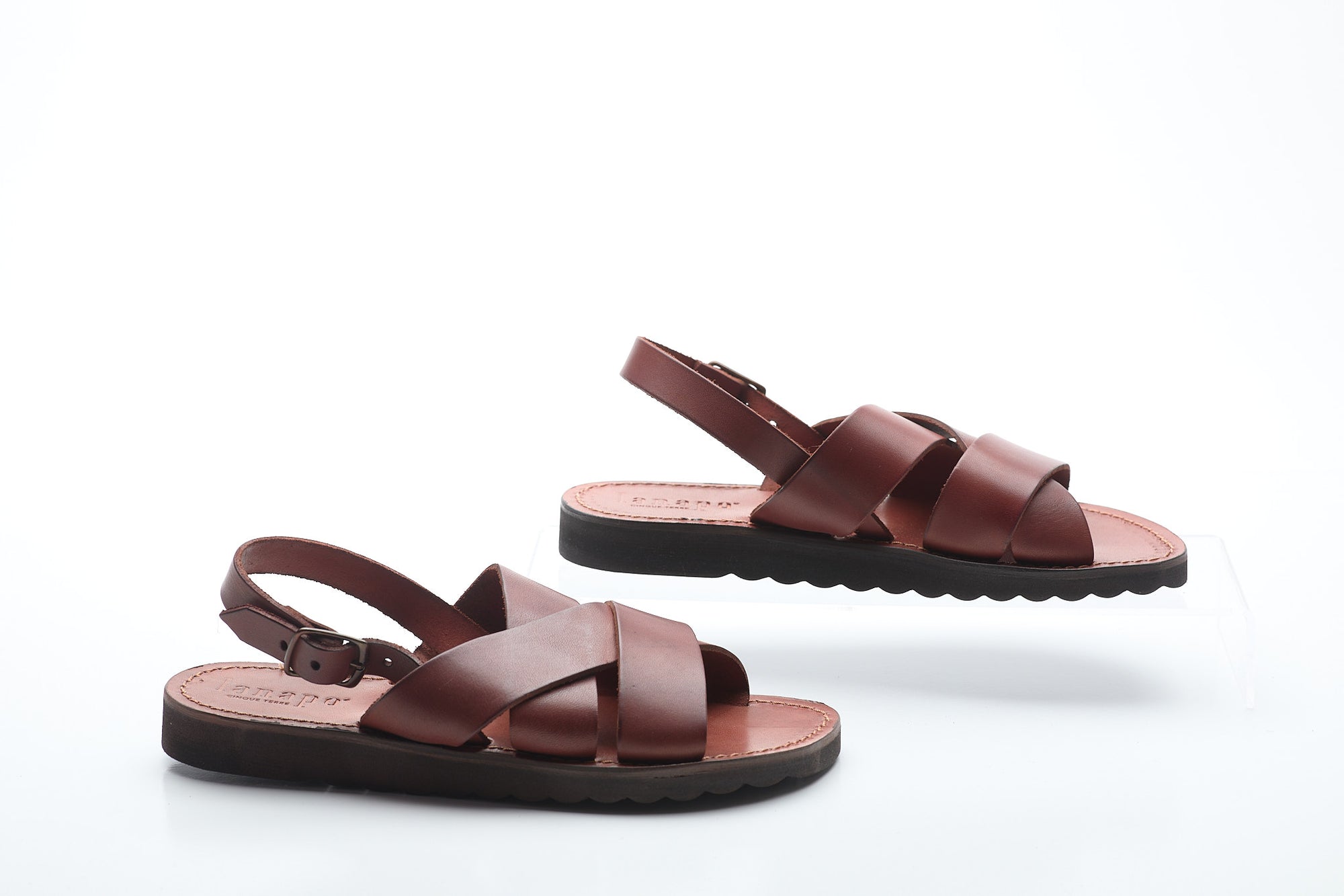 Pair of brown sandals on a white background