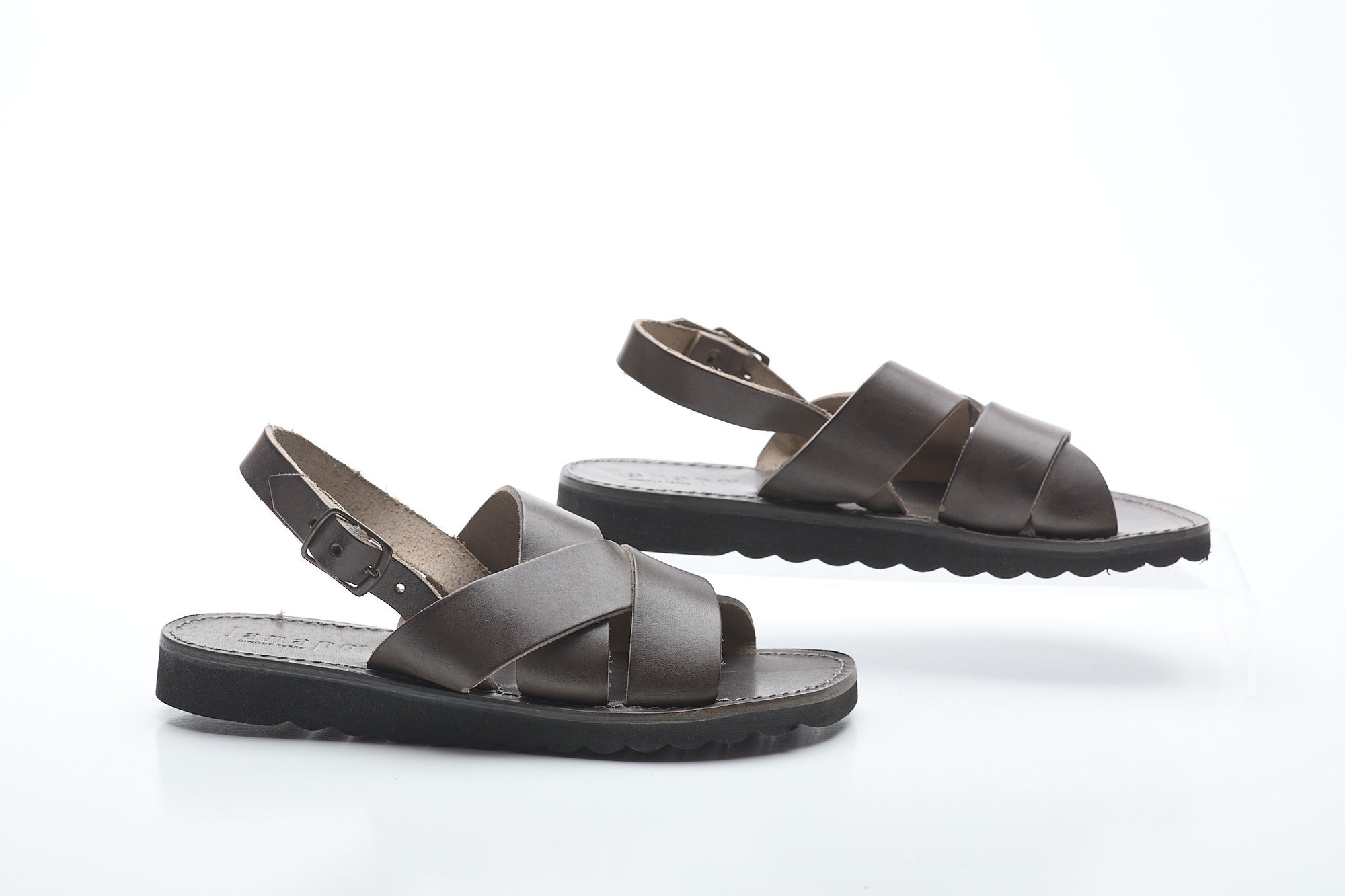 Pair of brown sandals on a white background