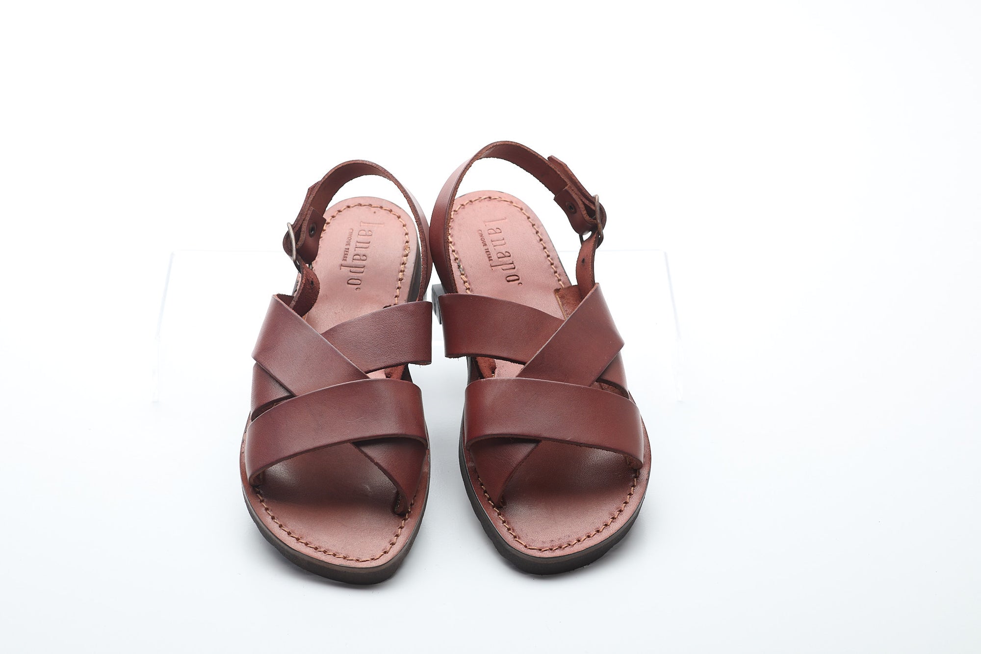 Pair of brown sandals on a white background