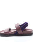 Purple sandal with a scrunchie on a white background