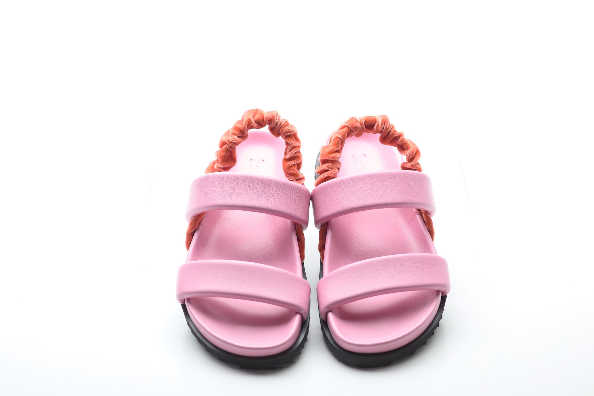 Pink sandals with orange straps on a white background