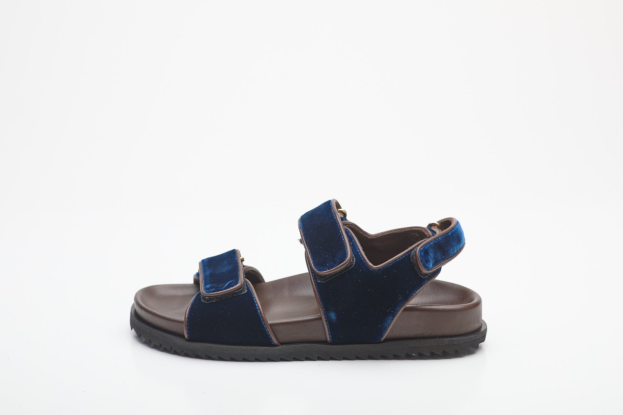 Navy sandal with brown sole on a white background