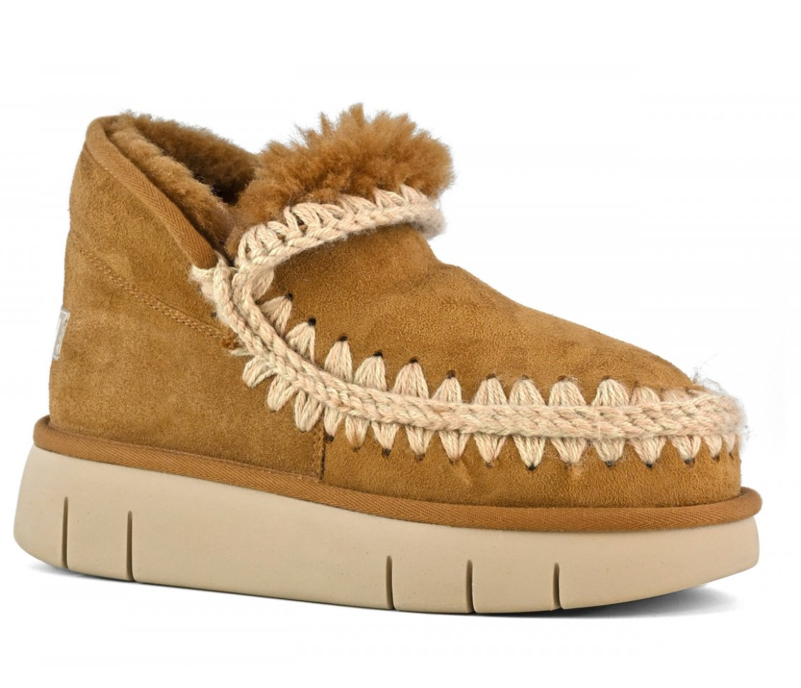 A brown MOU bounce sneaker with hand-crochet wool stitching and a flat rubber sole.