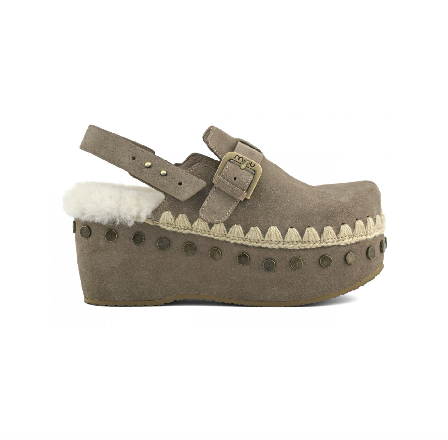 A taupe-brown suede clog shoe with a white shearling lining, a platform sole, and bronze-tone metal studs and buckle details, shown from a side profile on a white background.