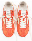 Pair of orange sneakers with white laces on a white background