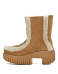 Tan platform boot with white fur trim on a white background