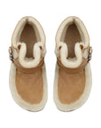 Pair of tan sheepskin boots with white fur lining on a white background