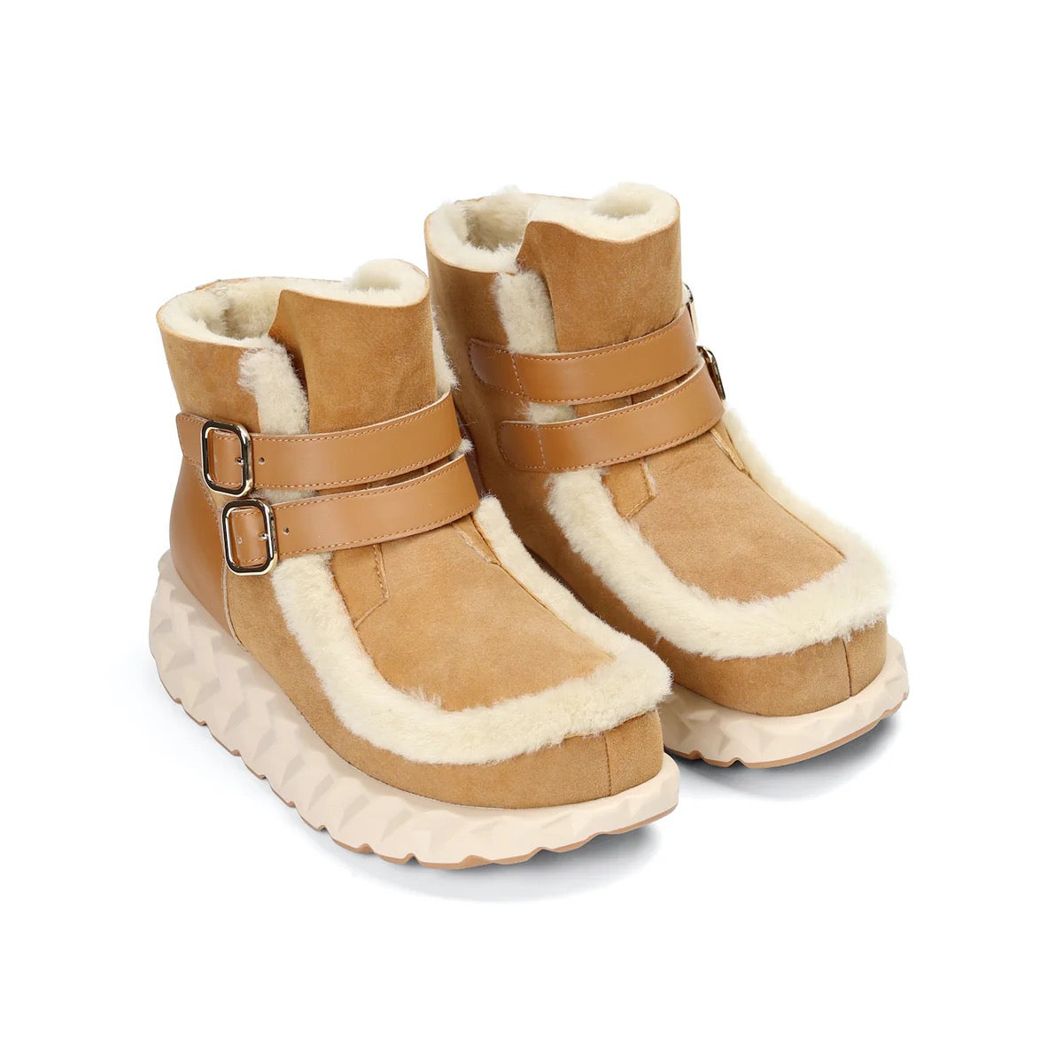Pair of tan winter boots with white fur lining on a white background
